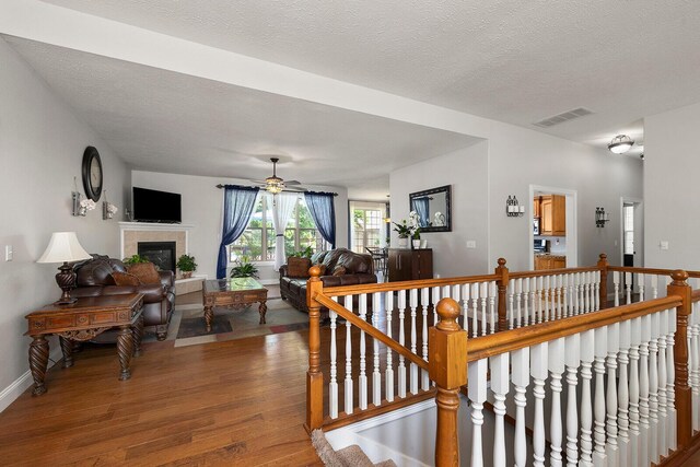 2310 Lakeside Ct, Ozark, MO 65721 - hall with wood finished floors, an upstairs landing, a textured ceiling, and baseboards