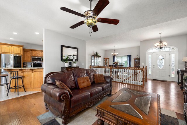 2310 Lakeside Ct, Ozark, MO 65721 - living room featuring a chandelier, light wood-style floors, recessed lighting, and a ceiling fan
