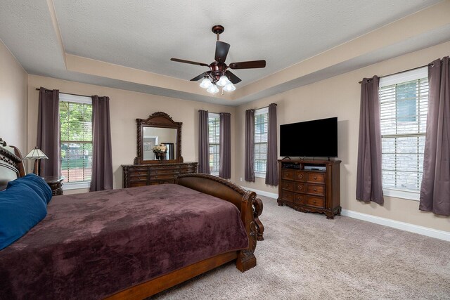 2310 Lakeside Ct, Ozark, MO 65721 - carpeted bedroom with baseboards, a tray ceiling, a textured ceiling, and a ceiling fan