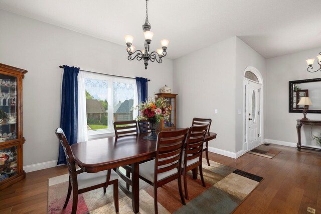 2310 Lakeside Ct, Ozark, MO 65721 - dining room with a chandelier, wood finished floors, and baseboards