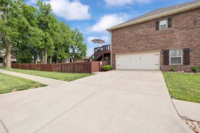 2310 Lakeside Ct, Ozark, MO 65721 - view of side of home with a garage, brick siding, and driveway