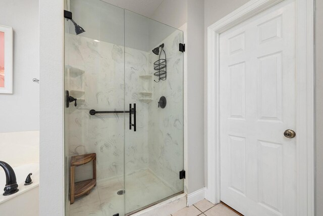 2310 Lakeside Ct, Ozark, MO 65721 - bathroom featuring a marble finish shower, a garden tub, and tile patterned flooring