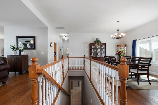 2310 Lakeside Ct, Ozark, MO 65721 - corridor featuring an upstairs landing, a chandelier, and wood-type flooring