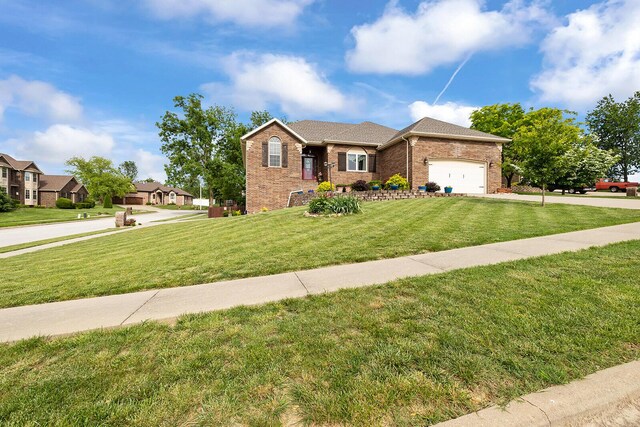 2310 Lakeside Ct, Ozark, MO 65721 - view of front facade featuring a front lawn, brick siding, an attached garage, and concrete driveway