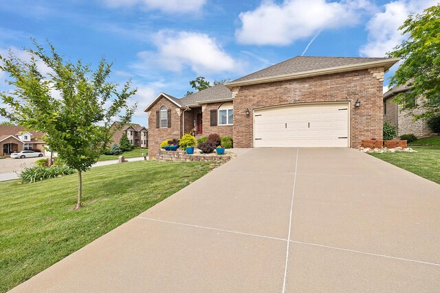 2310 Lakeside Ct, Ozark, MO 65721 - ranch-style home featuring concrete driveway, a front lawn, a garage, and brick siding