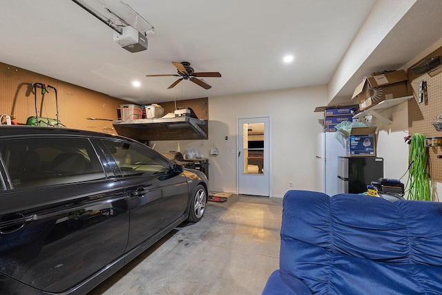 2310 Lakeside Ct, Ozark, MO 65721 - garage with a garage door opener, freestanding refrigerator, ceiling fan, recessed lighting, and baseboards