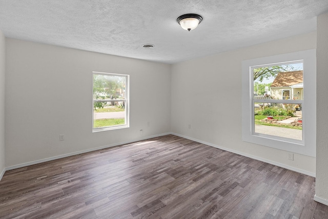 1433 E 24th St N, Springfield, MO 65803 - unfurnished room with wood finished floors, a textured ceiling, and baseboards