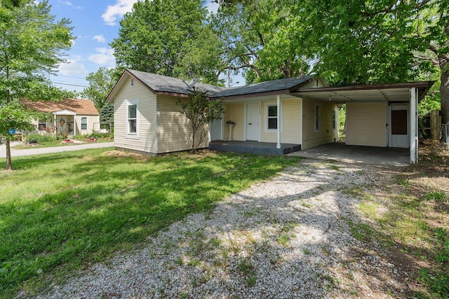 1433 E 24th St N, Springfield, MO 65803 - view of front facade with driveway, a front lawn, a carport, and a porch