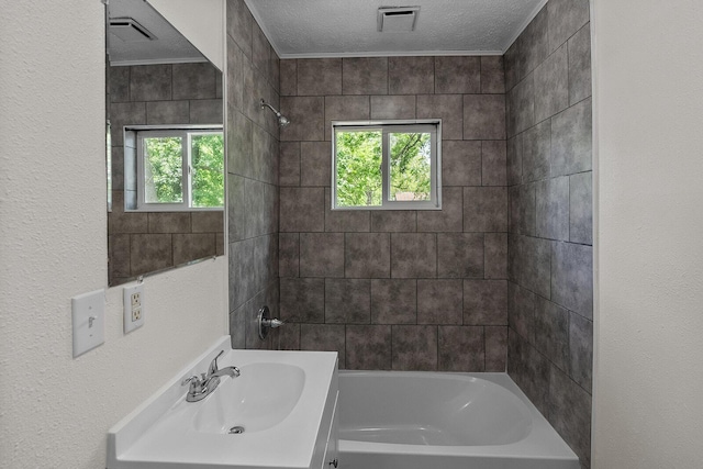 1433 E 24th St N, Springfield, MO 65803 - full bathroom with healthy amount of natural light, a textured ceiling, bathtub / shower combination, and vanity