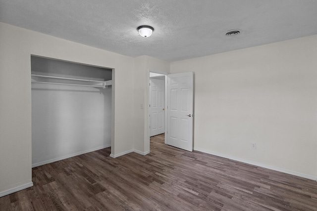 1433 E 24th St N, Springfield, MO 65803 - unfurnished bedroom featuring wood finished floors, baseboards, a closet, and a textured ceiling