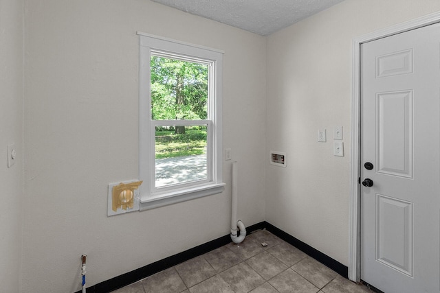 1433 E 24th St N, Springfield, MO 65803 - washroom with hookup for a washing machine, light tile patterned floors, baseboards, and a textured ceiling