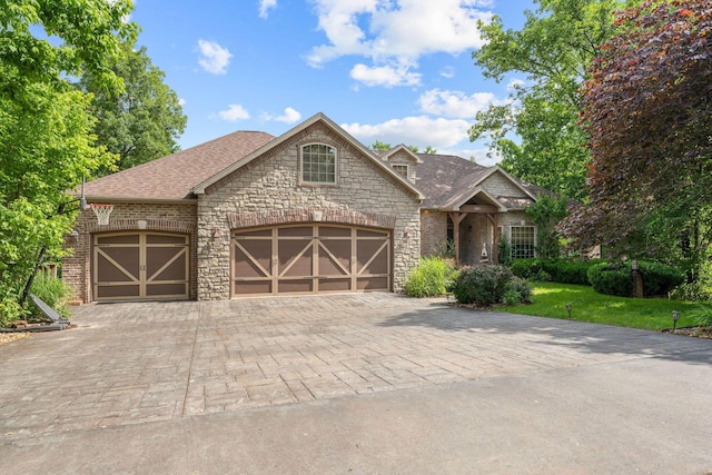 261 Country Bluff Dr, Branson, MO 65616 - french country style house with stone siding, driveway, a garage, roof with shingles, and a front lawn