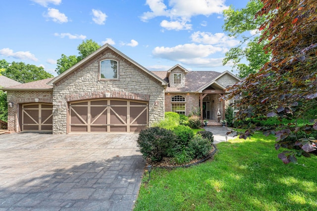 261 Country Bluff Dr, Branson, MO 65616 - view of front of house with a front lawn, an attached garage, decorative driveway, a shingled roof, and brick siding