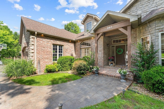 261 Country Bluff Dr, Branson, MO 65616 - doorway to property with roof with shingles, stone siding, and brick siding
