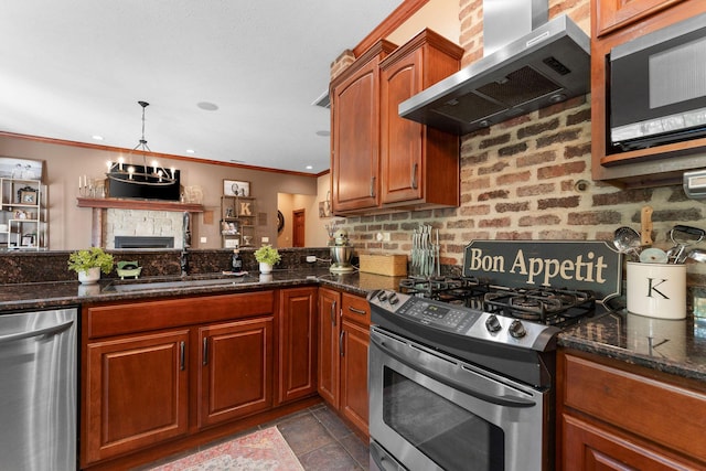 261 Country Bluff Dr, Branson, MO 65616 - kitchen with stainless steel appliances, wall chimney exhaust hood, a sink, crown molding, and a fireplace