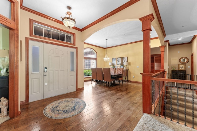 261 Country Bluff Dr, Branson, MO 65616 - entrance foyer featuring hardwood / wood-style flooring, ornamental molding, decorative columns, baseboards, and arched walkways