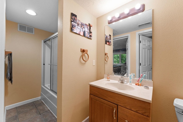 261 Country Bluff Dr, Branson, MO 65616 - full bath with vanity, toilet, baseboards, tile patterned flooring, and enclosed tub / shower combo