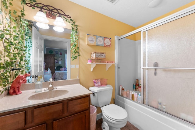 261 Country Bluff Dr, Branson, MO 65616 - bathroom with vanity, connected bathroom, shower / bath combination with glass door, and toilet