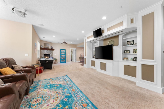 261 Country Bluff Dr, Branson, MO 65616 - carpeted living room featuring a ceiling fan, a fireplace, recessed lighting, built in features, and a textured ceiling