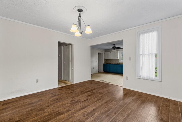 537 S Jefferson Ave, Aurora, MO 65605 - unfurnished living room with wood finished floors, a chandelier, healthy amount of natural light, ornamental molding, and baseboards