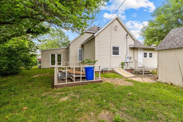 537 S Jefferson Ave, Aurora, MO 65605 - back of property with a yard, entry steps, a shingled roof, and french doors