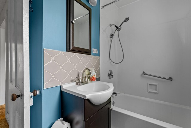 537 S Jefferson Ave, Aurora, MO 65605 - bathroom with  shower combination, vanity, and decorative backsplash