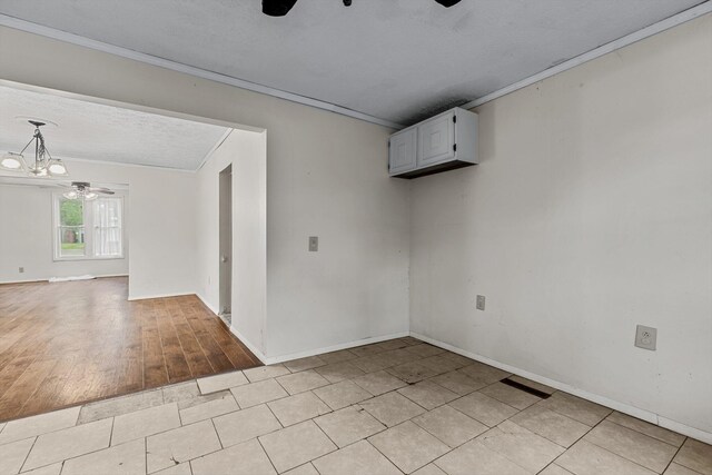537 S Jefferson Ave, Aurora, MO 65605 - empty room with ceiling fan, ornamental molding, baseboards, light tile patterned flooring, and a textured ceiling
