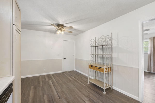 127 Wilson Way, Marshfield, MO 65706 - unfurnished dining area with dark wood-style floors, a textured ceiling, a ceiling fan, and baseboards