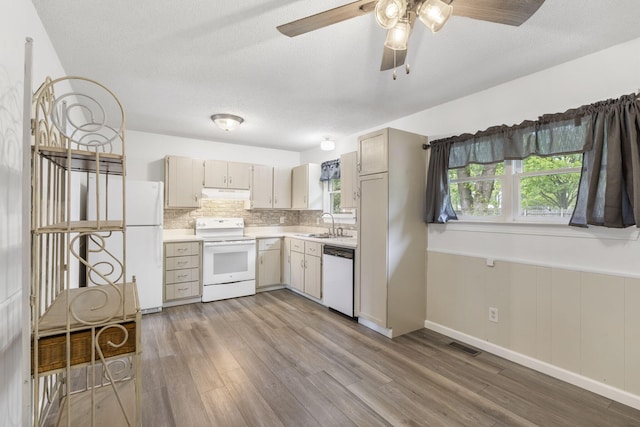 127 Wilson Way, Marshfield, MO 65706 - kitchen featuring white appliances, under cabinet range hood, light countertops, light wood-style flooring, and ceiling fan