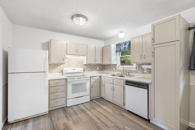 127 Wilson Way, Marshfield, MO 65706 - kitchen with white appliances, a sink, under cabinet range hood, light countertops, and tasteful backsplash