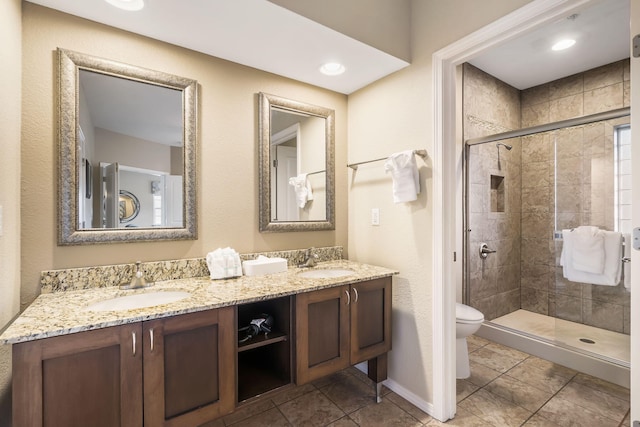 2800 Green Mountain Dr Unit 231, Branson, MO 65616 - bathroom featuring toilet, a stall shower, and double vanity