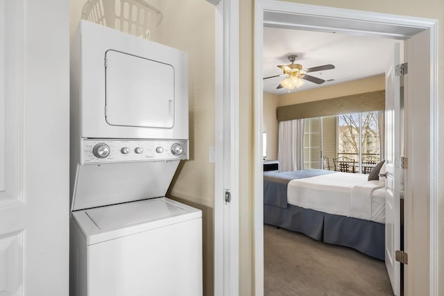 2800 Green Mountain Dr Unit 231, Branson, MO 65616 - washroom featuring estacked washer and dryer, carpet, and a ceiling fan