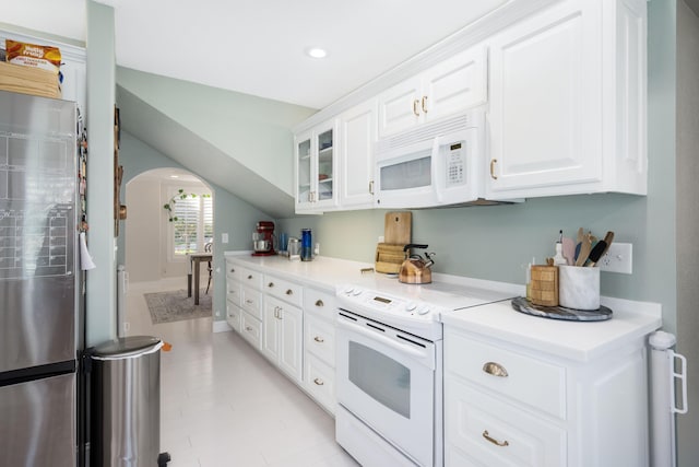 2820 Waters Edge Blvd, Joplin, MO 64801 - kitchen with white appliances, arched walkways, white cabinetry, glass insert cabinets, and recessed lighting