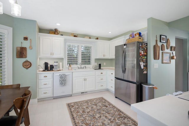 2820 Waters Edge Blvd, Joplin, MO 64801 - kitchen featuring freestanding refrigerator, dishwasher, a sink, white cabinets, and light countertops