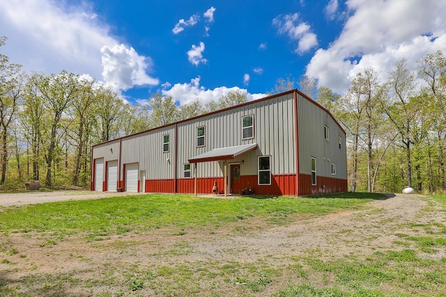 217 Victory Ln, Niangua, MO 65713 - view of front facade with dirt driveway and board and batten siding