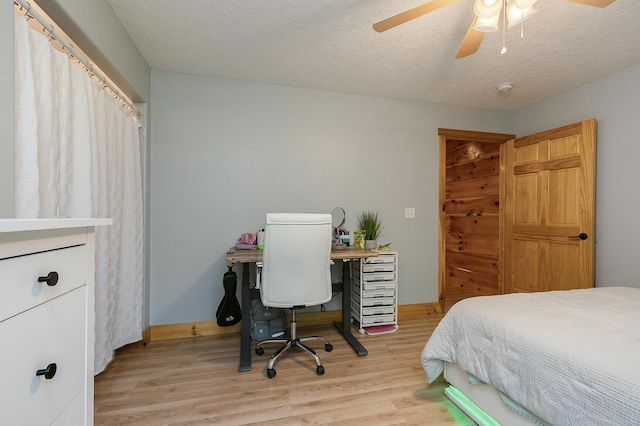 217 Victory Ln, Niangua, MO 65713 - bedroom with wood finished floors, baseboards, ceiling fan, and a textured ceiling