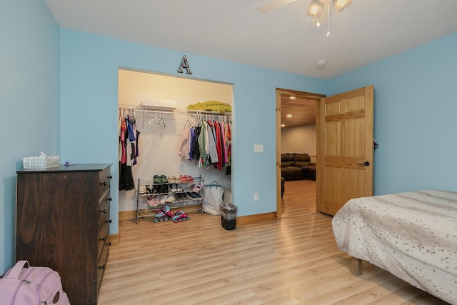 217 Victory Ln, Niangua, MO 65713 - bedroom with wood finished floors, a closet, a spacious closet, baseboards, and a ceiling fan