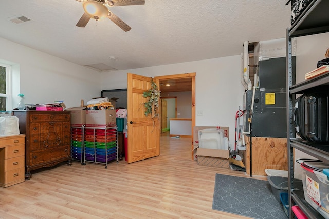 217 Victory Ln, Niangua, MO 65713 - rec room with light wood-style flooring, ceiling fan, and a textured ceiling