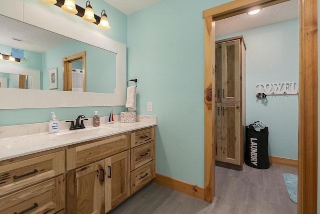 217 Victory Ln, Niangua, MO 65713 - bathroom featuring wood finished floors, baseboards, and vanity