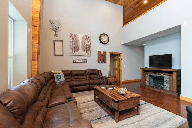 217 Victory Ln, Niangua, MO 65713 - living area with baseboards, a towering ceiling, a fireplace, wood ceiling, and recessed lighting