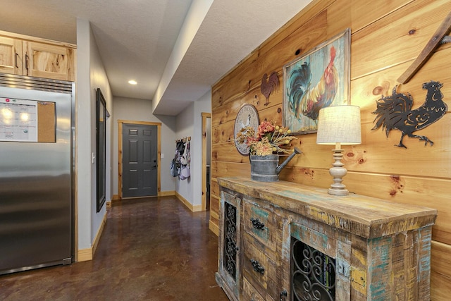 217 Victory Ln, Niangua, MO 65713 - hallway featuring baseboards, concrete floors, wooden walls, and recessed lighting