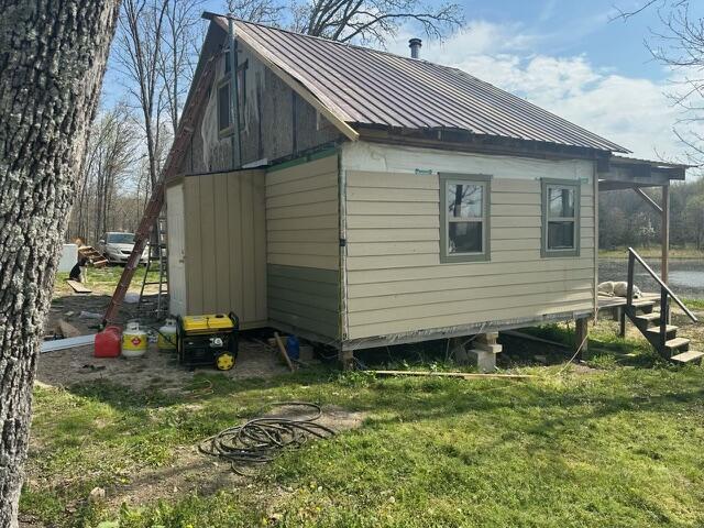 1832 County Road 2030, Mountain View, MO 65548 - view of property exterior with a yard, metal roof, and an outbuilding