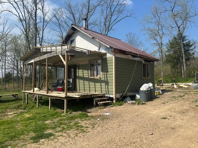 1832 County Road 2030, Mountain View, MO 65548 - view of home's exterior with a deck and metal roof