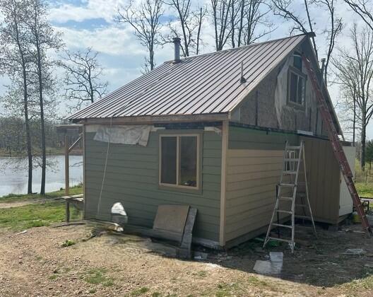 1832 County Road 2030, Mountain View, MO 65548 - view of property exterior featuring a water view, metal roof, and a standing seam roof
