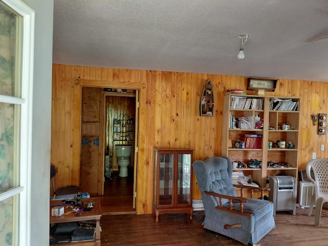 605 N Marr St, Mountain View, MO 65548 - living area featuring wood walls, wood finished floors, and a textured ceiling