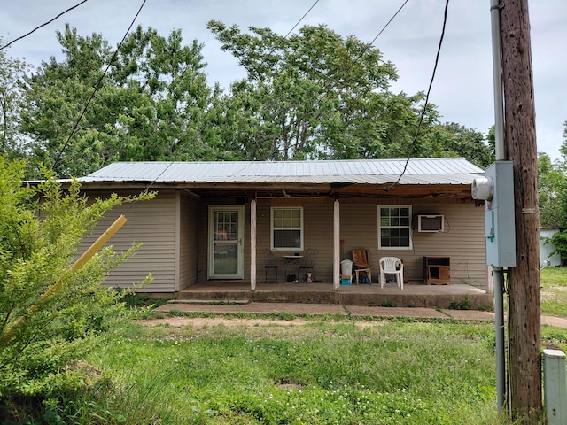 605 N Marr St, Mountain View, MO 65548 - view of front of property featuring covered porch, metal roof, and an AC wall unit