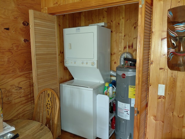 605 N Marr St, Mountain View, MO 65548 - laundry area featuring stacked washer / drying machine, electric water heater, and wooden walls