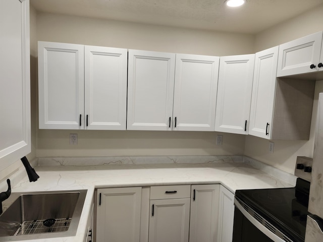 313 N Mill St, Marshfield, MO 65706 - kitchen featuring electric range, white cabinetry, light stone countertops, a sink, and recessed lighting