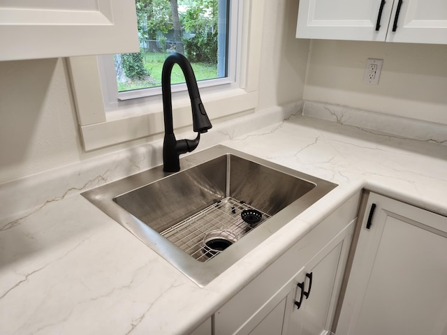 313 N Mill St, Marshfield, MO 65706 - kitchen view of a sink, white cabinets, and light stone counters