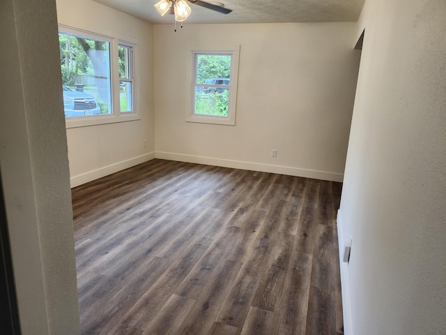 313 N Mill St, Marshfield, MO 65706 - unfurnished room with plenty of natural light, baseboards, dark wood finished floors, and a ceiling fan